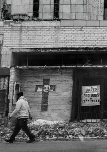 black and white photo of brick wall with cross